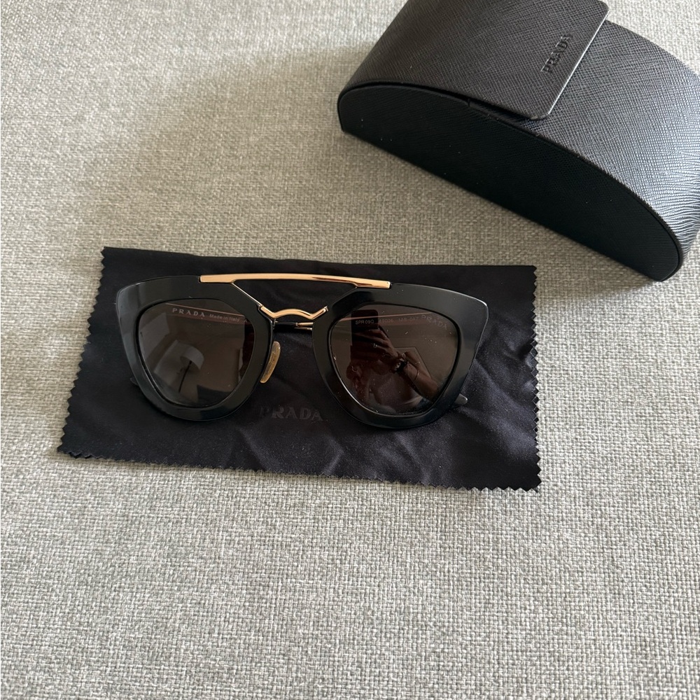 Prada Women's Sunglasses in Black with Gold Detail